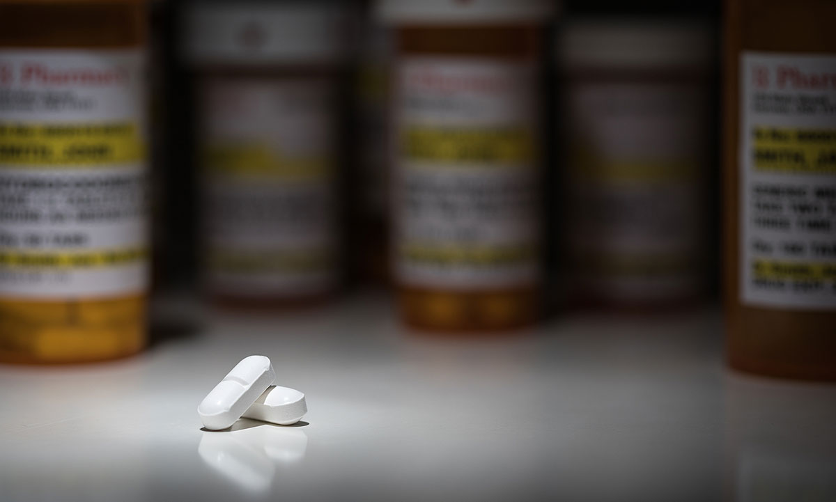 Pills and Prescription Bottles Under Spot Light. Concept of Vicodin addiction and Vicodin Rapid Detox Center