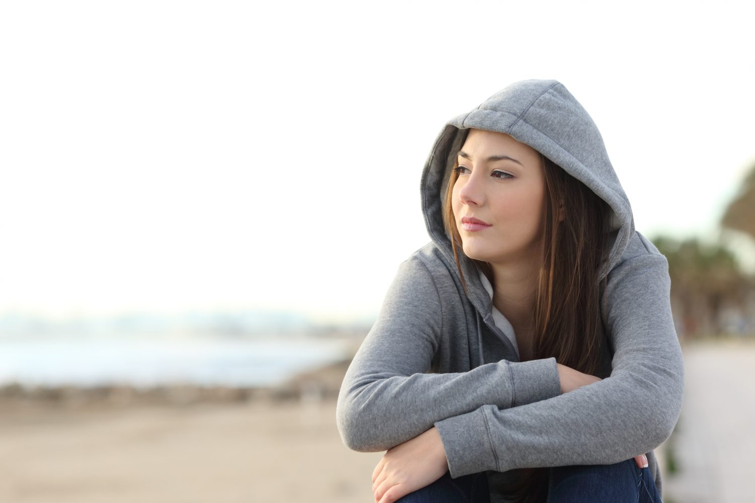 women wearing sweatshirt looking away; thinking about vivitrol for opioid addiction