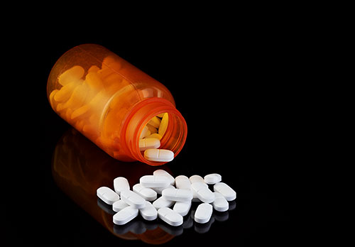 Opioid use disorder; pill bottle spilling out opioids