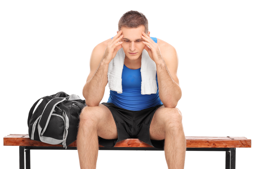 Athlete sitting on bench depressed illustrating that high school athletes become heroin-addicted