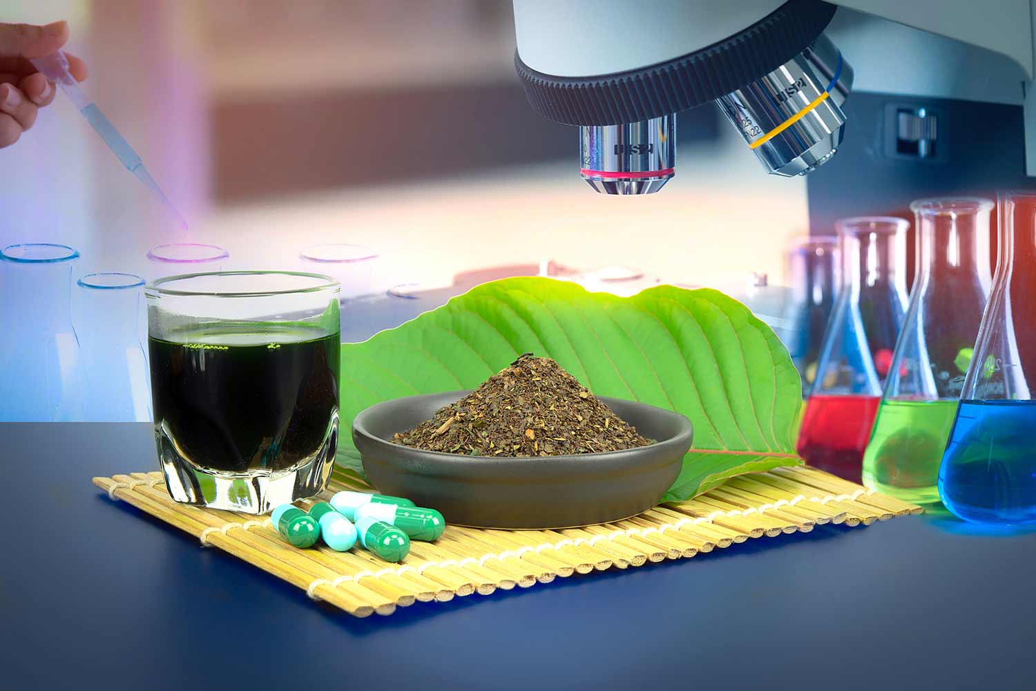 Rapid Kratom Detox Concept: Mitragynina speciosa or Kratom leaves with powder product in white ceramic bowl and water from the extracts the kratom leaves. Supplement kratom green capsules. scientist working at the laboratory with color liquids in glassware and Mitragyna speciosa 